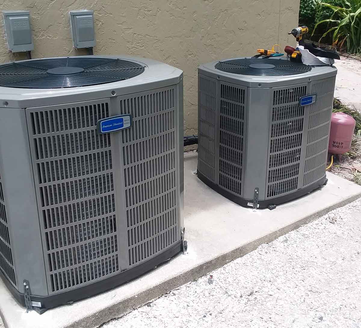 Air conditioning condenser installed outside a home