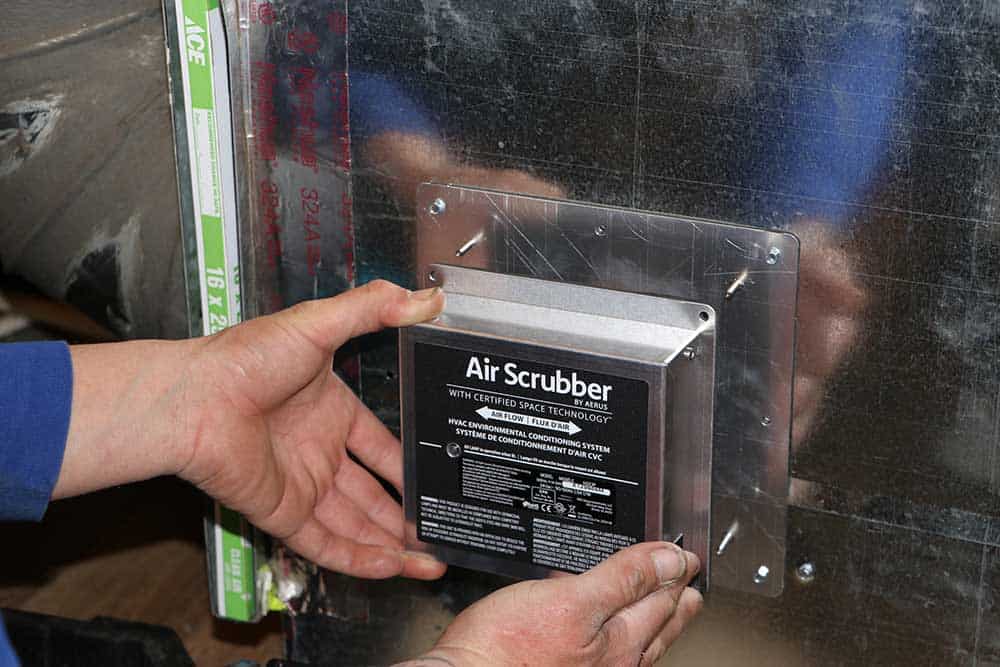 Genesis technician servicing an air scrubber