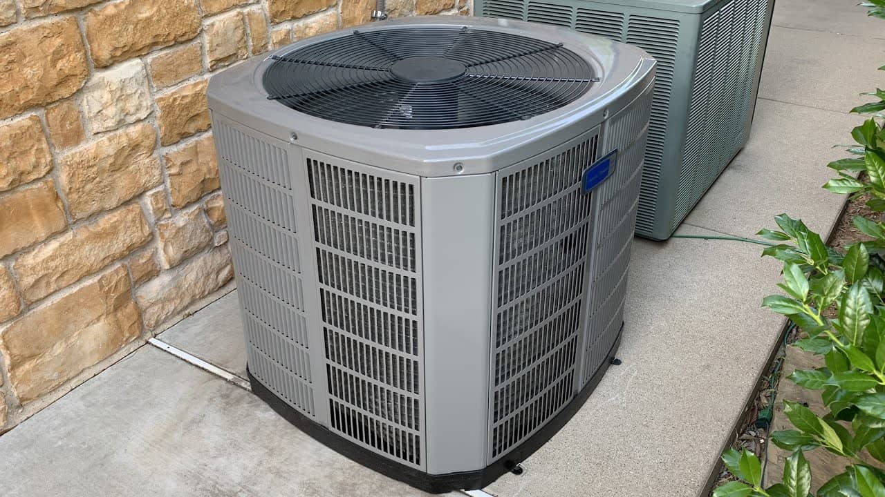Air conditioning condenser installed outside a home