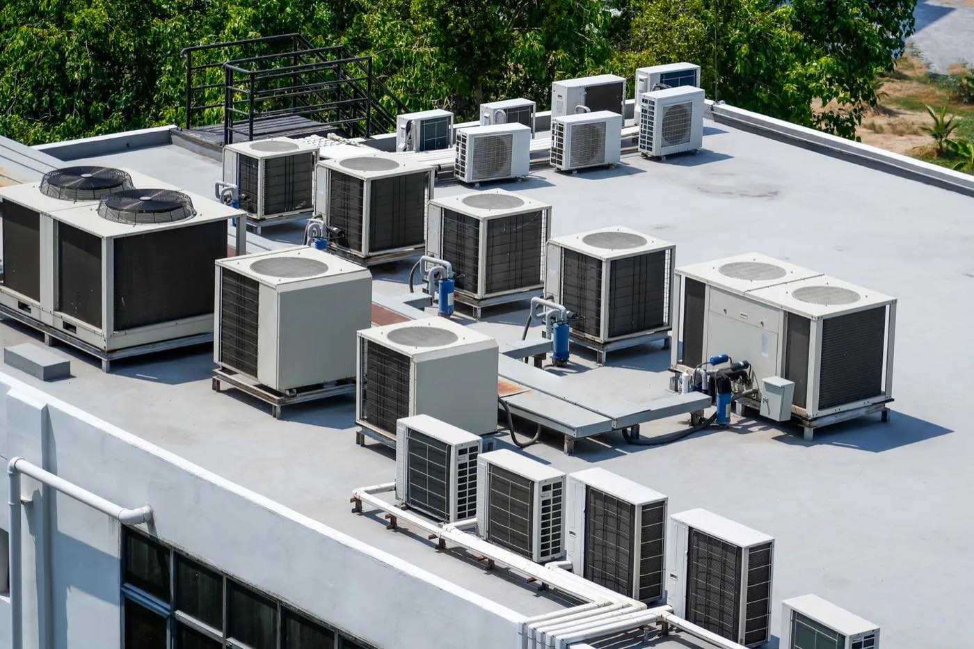Packaged rooftop units and ductless condensers on a commercial flat roof