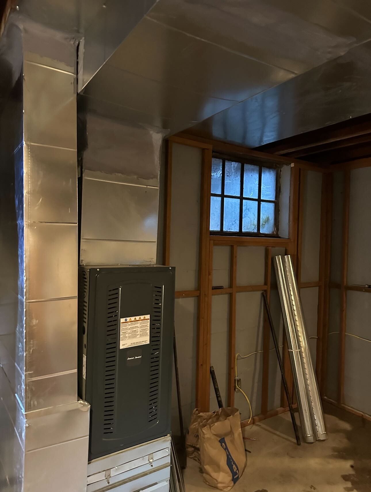 Installing new ductwork to properly heat both floors.
